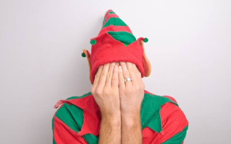 Featured images of elf covering face for 10 tips to eliminate holiday stress